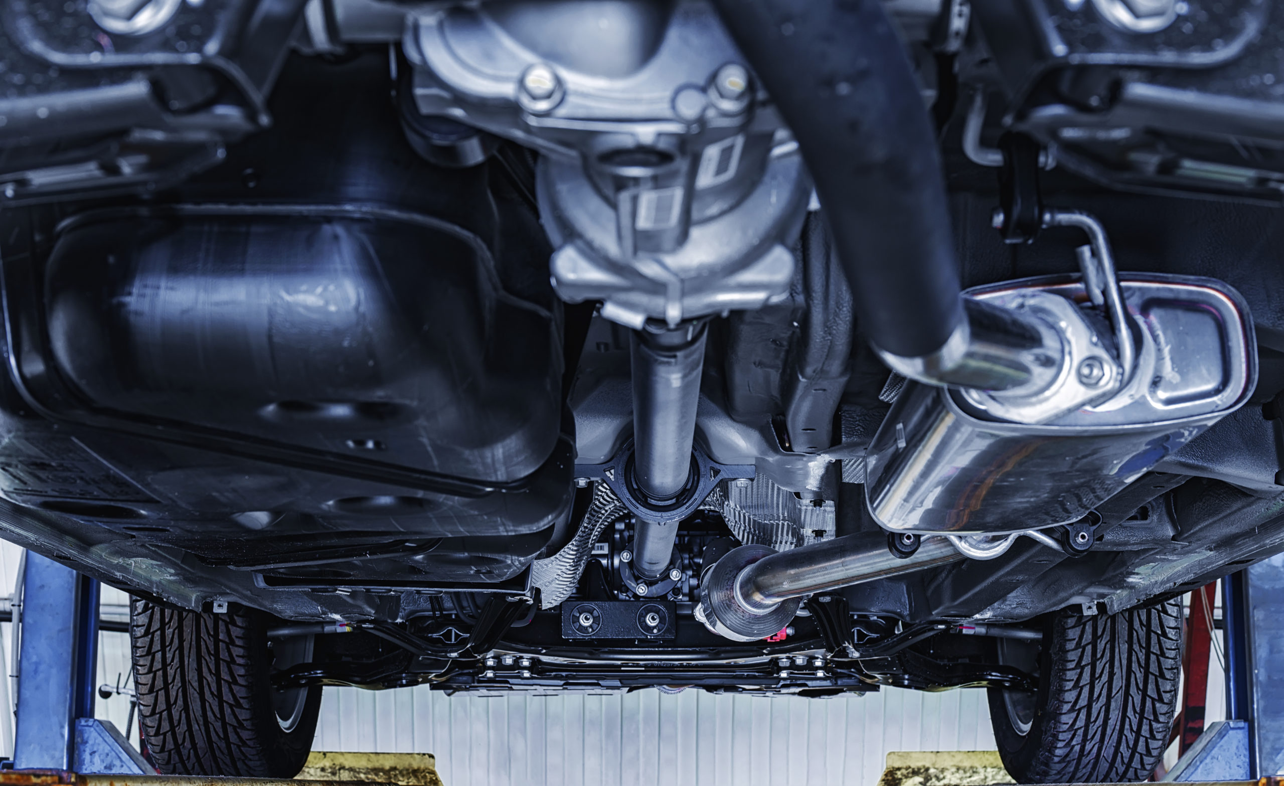 view of the car from below on the lift at shallow depth of field